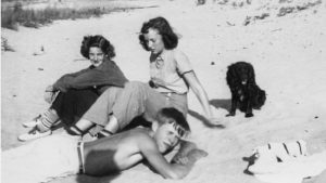 Martha Rule, Janet Graph, and Jack Stevenson on the beach with their dog. Courtesy Omena Historical Society