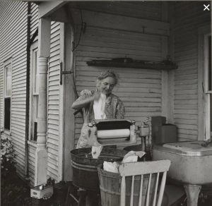 Washing laundry on back porch