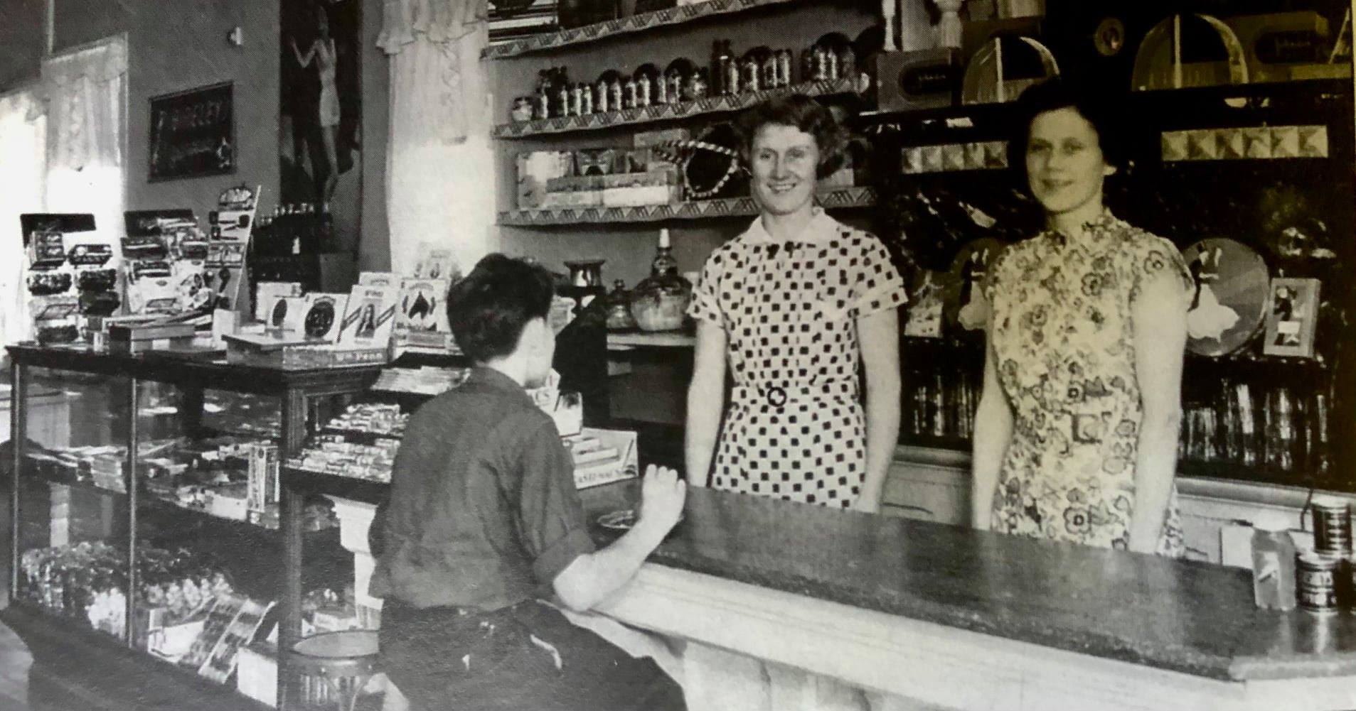 Gorden Solle, Elsie and Genvea Putnam Smith at the counter in Anderson's Ice Cream Parlor in 1935. This was where currently the Omena Post Office is. Photo Courtesy of Sally Viskochil and Omena Historical Society