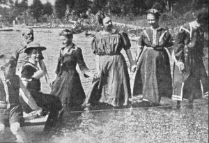 These ladies wading in Omena Bay circa 1920 were just happy to get their feet wet! Courtesy Kay Harris, Omena, a Place in Time
