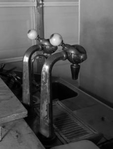 Soda dispensers arch over the counter.