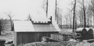 You can see the steam rising from the vent in the roof of this Sugar Shack. Often they were located in a Sugar Bush or Maple woods.