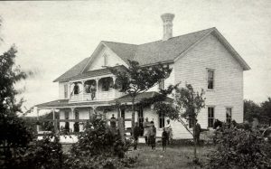 Aaron Page's boarding house served loggers and early settlers, and was the location of the first Post Office until 1881. This photo (ca 1905) was taken just after the logging ended and tourists began to come to Omena) - courtesy Omena Historical Society