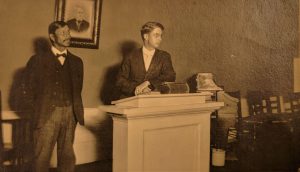 Jacob Ahgosa, Elder and grandson of the first Chief Ahgosa, and Reverend Plymate deliver the service one Sunday morning. Usually, the townspeople sat on the east side and the Native Americans, and a few local residents sat on the west side so Jacob Ahgosa could translate the service for the Indians assembled.