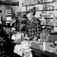 Inside Barth's store, Ernie and a customer, sometime during the 1950s. - Courtesy Omena Historical Society Inside Barth's store, Ernie and a customer, sometime during the 1950s. - Courtesy Omena Historical Society