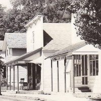 In this photo you can see the sloped roof of the second story of the Post Office building. This might have been bedrooms for Jeannette's little family. You must stand in the middle or you risk a head bump. - Courtesy Omena Historical Society Omena Post Office