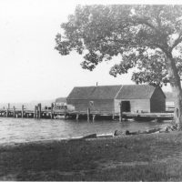 The dock stands alone, waiting for passengers or freight, the storage shed empty for now.
Photo courtesy of Omena Historical Society The dock stands alone, waiting for passengers or freight, the storage shed empty for now. Photo courtesy of Omena Historical Society