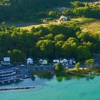 From the air, you can still see the remains of the Anderson Dock in the lower right-hand corner. Toward shore you can see the Omena public swimming beach. - Photo Credit: Mason Groot Kadima Drone Services From the air, you can still see the remains of the Anderson Dock in the lower right-hand corner. Toward shore you can see the Omena public swimming beach. - Photo Credit: Mason Groot Kadima Drone Services